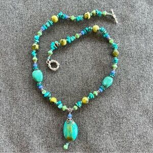 Turquoise, lapis, and glass bead necklace with a teardrop pendant silver clasp